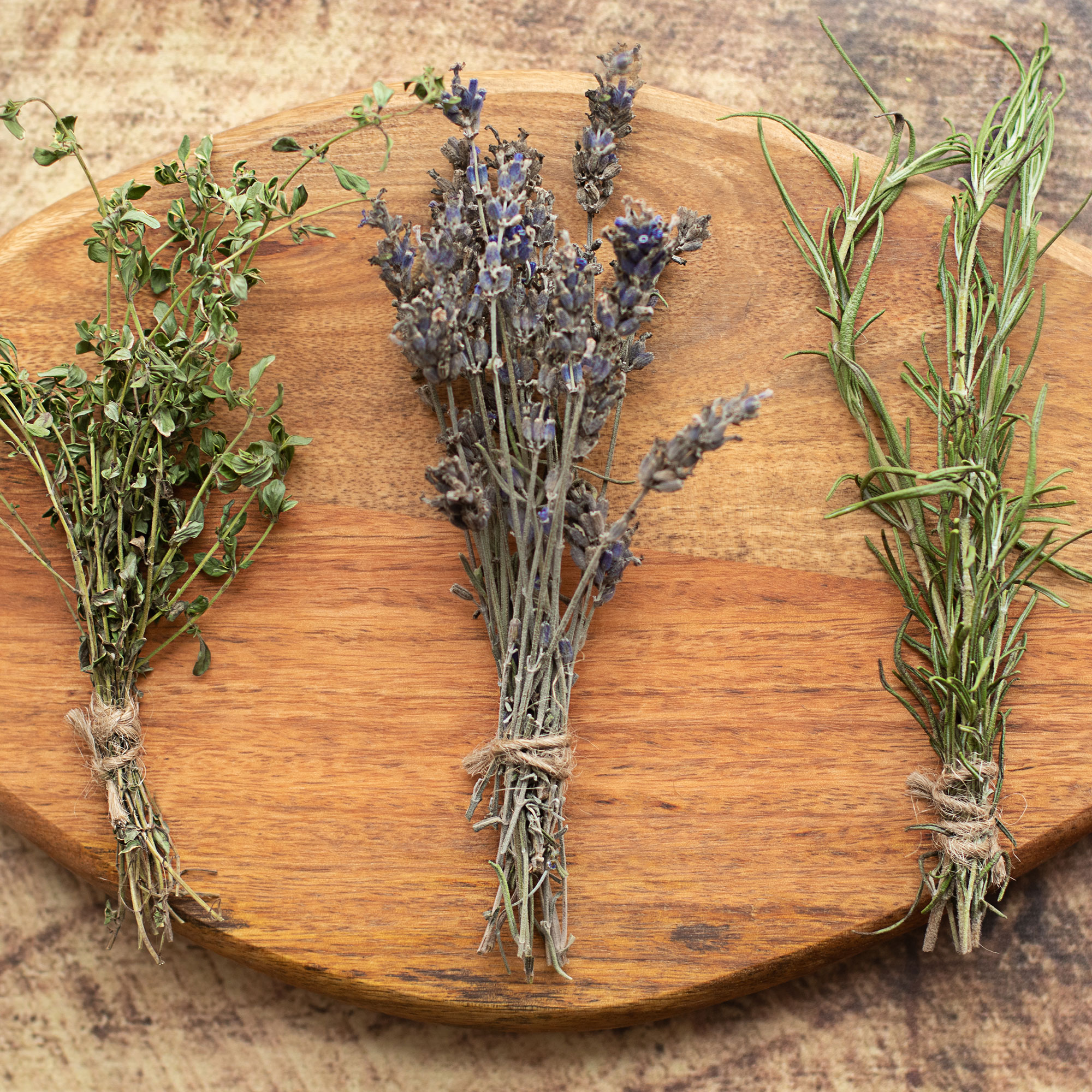 Bunches of dried herbs on wooden board
