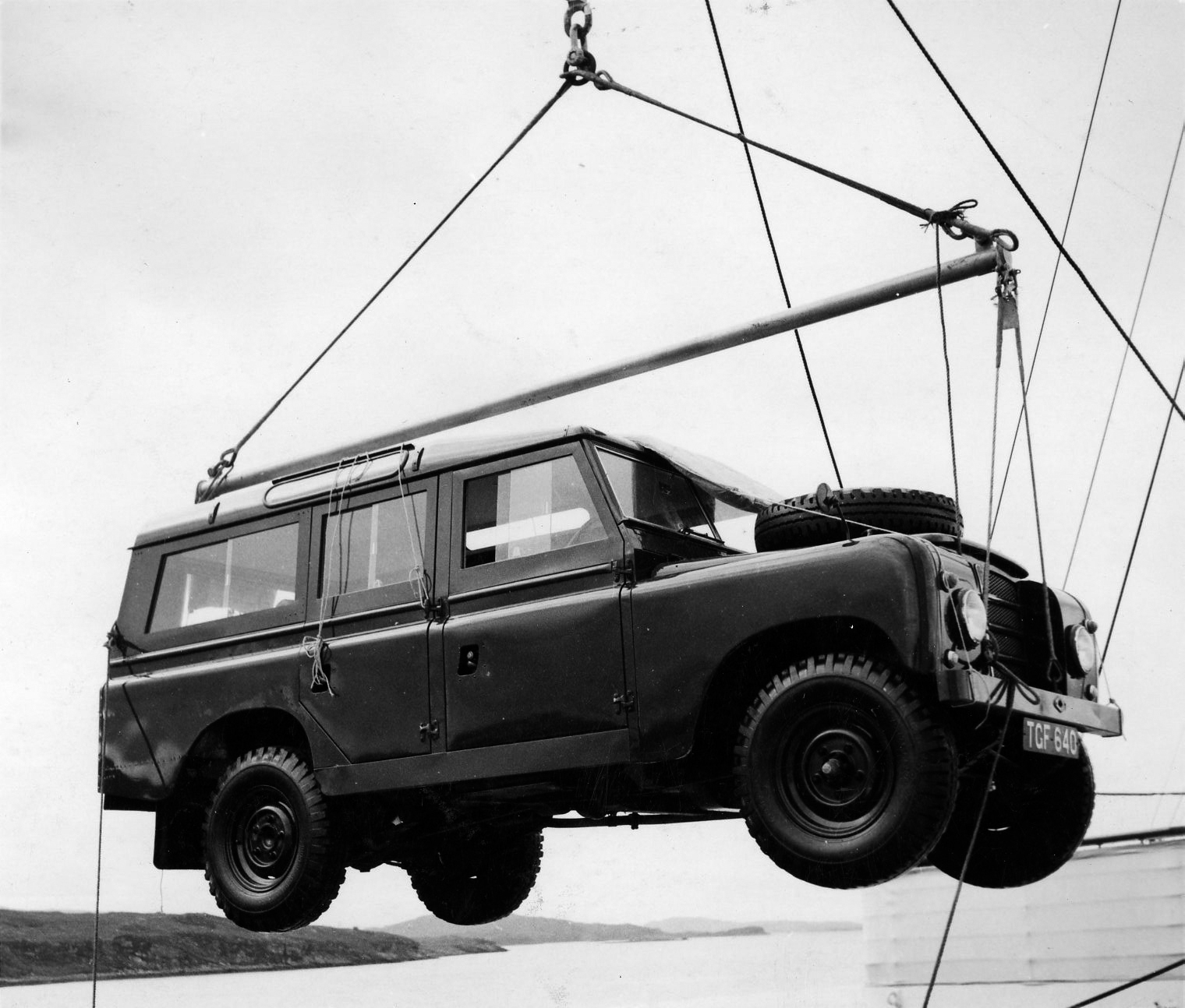 The Royal Land Rover is towed aboard Britannia via a crane.