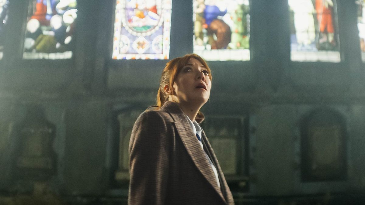 Philomena Cunk actress Diane Morgan posing in a church, looking up