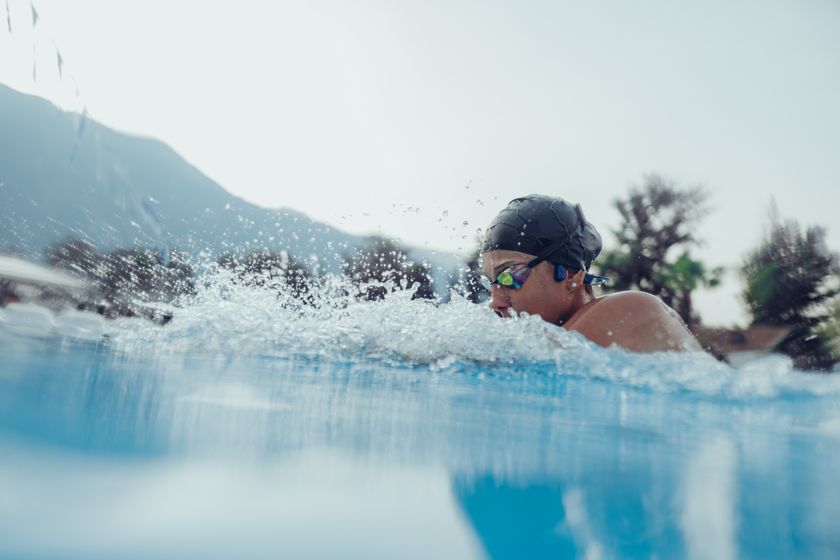 Person swimming wearing bone conduction earphones