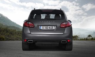 Rear view of a grey Porsche Cayenne S Diesel with trees in the distance
