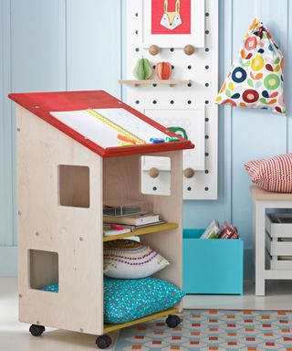 childrens room with blue wall study area and adjustable shelf table