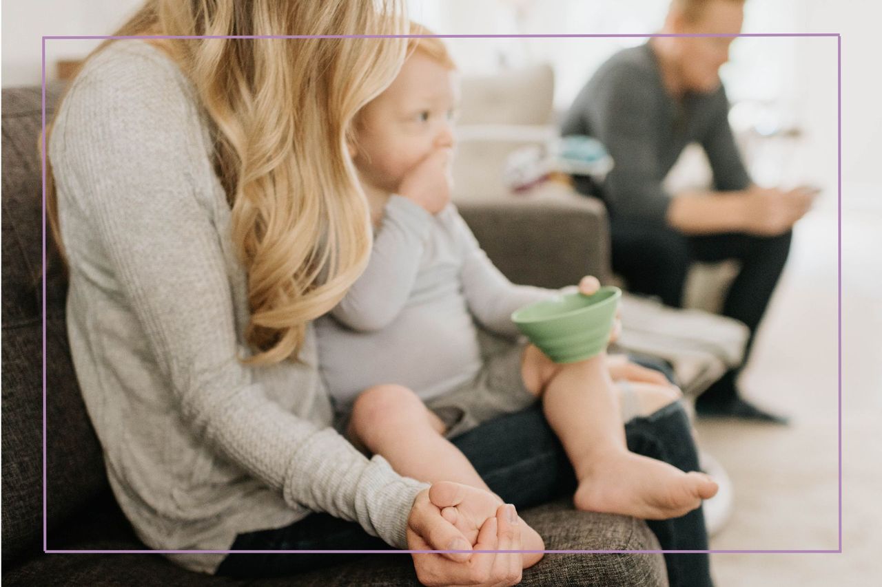 Divorce after a baby illustrate by woman holding a baby with man in background