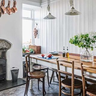 dinning area with white wall wooden dinning table and chair