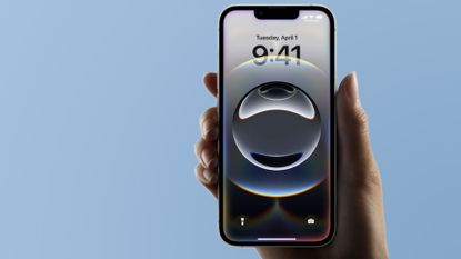 Apple iPhone 16e held in hand on blue background