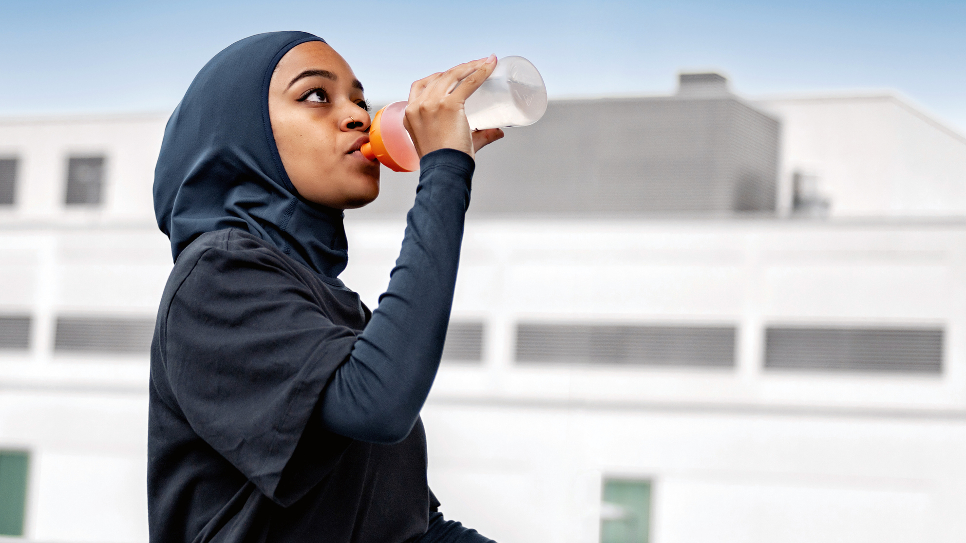 Woman drinking from sports bottle