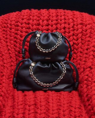 black Loewe Flamenco clutches on top of red crochet