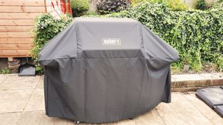 Weber Genesis EPX-335 with protective cover on it