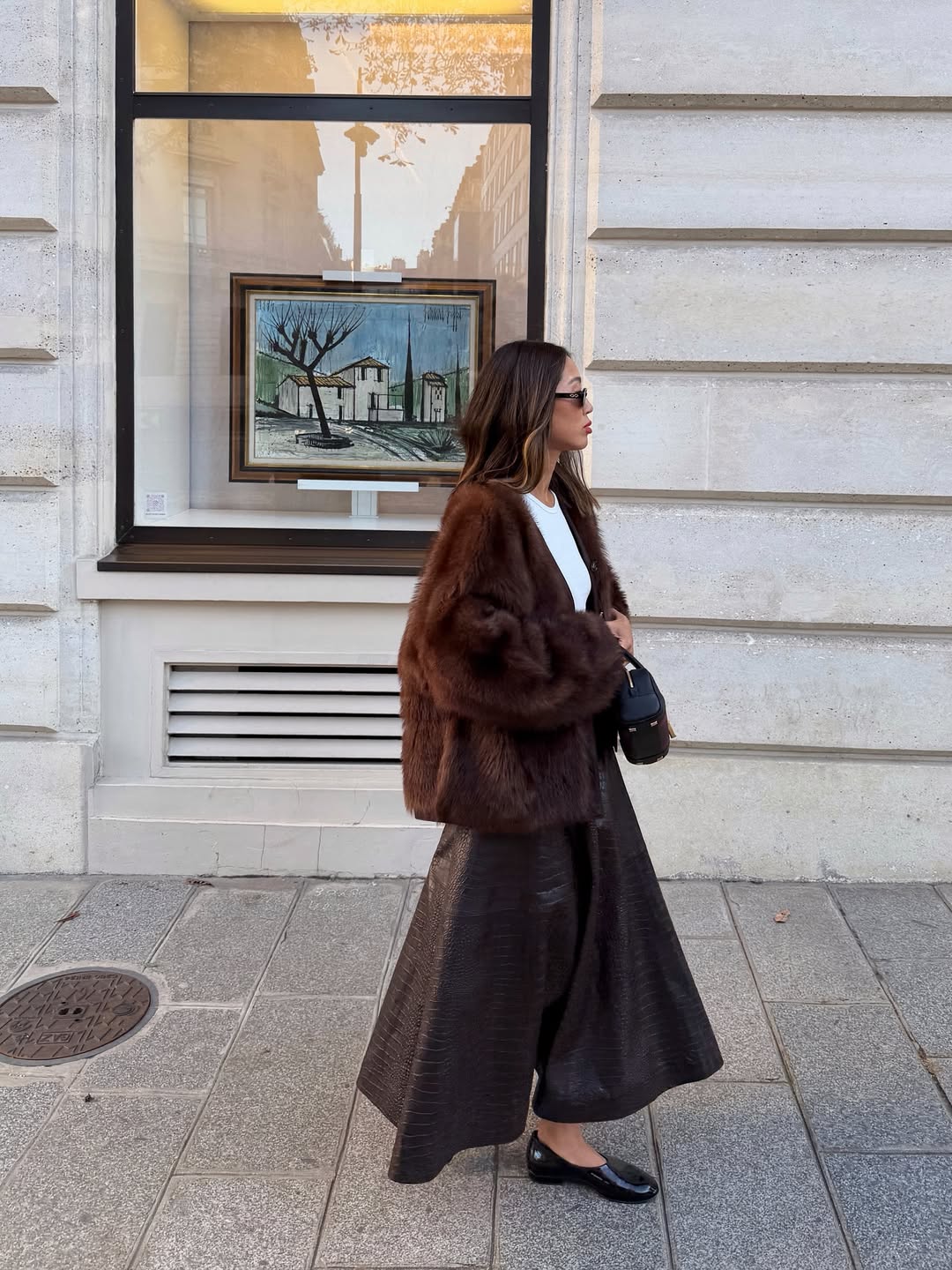 Influencer Aimee Song wearing a leather skirt and faux fur jacket