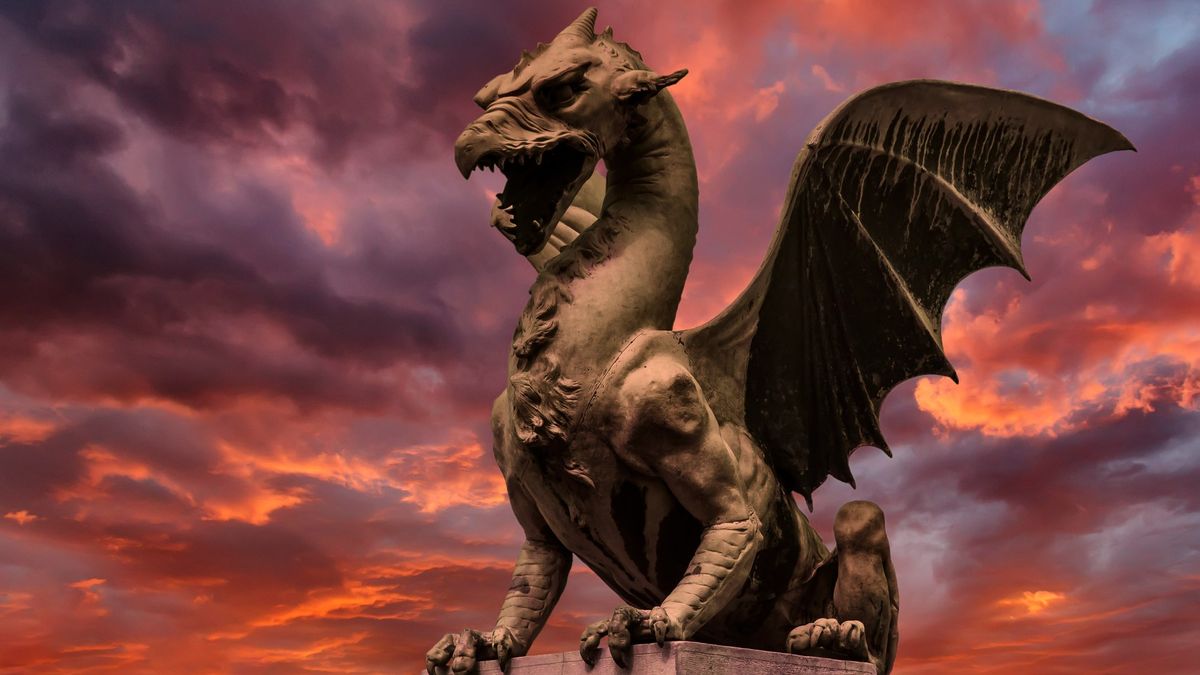 A statue of a Dragon against a blazing sunset, located in Ljubljana, Slovenia