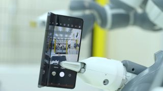 Robot arm holding a Samsung Galaxy Z Fold 5