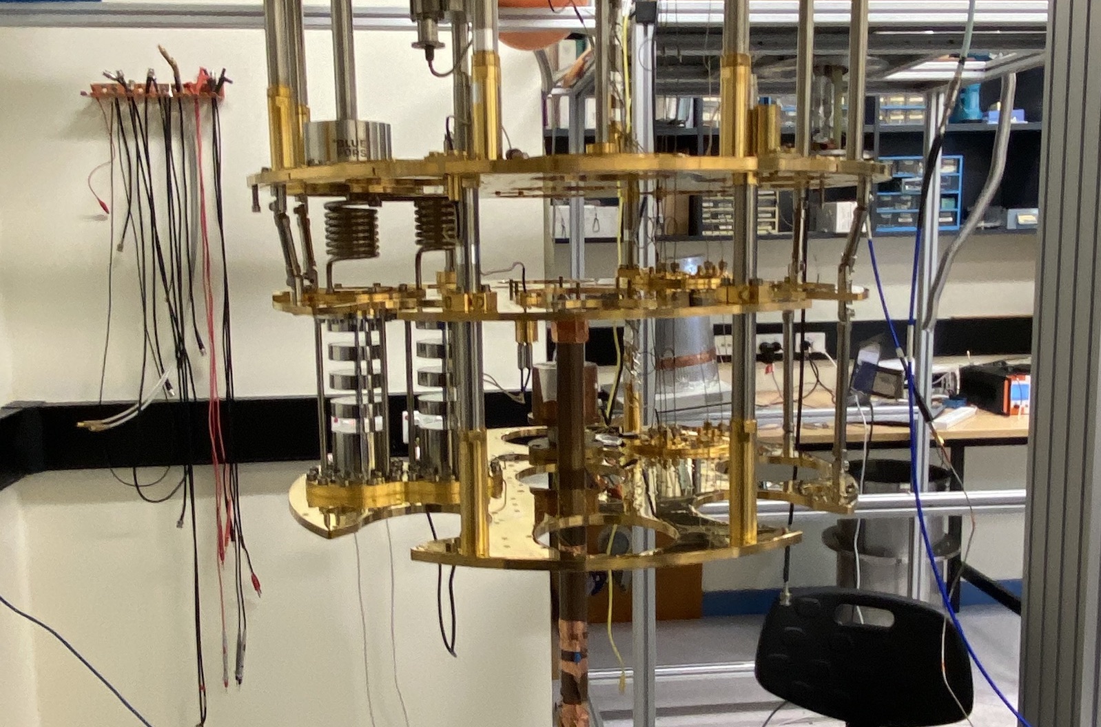 The ORGAN Experiment's main detector. A small copper cylinder called a 'resonant cavity' traps photons generated during dark matter conversion. The cylinder is bolted to a 'dilution refrigerator' which cools the experiment to very low temperatures.