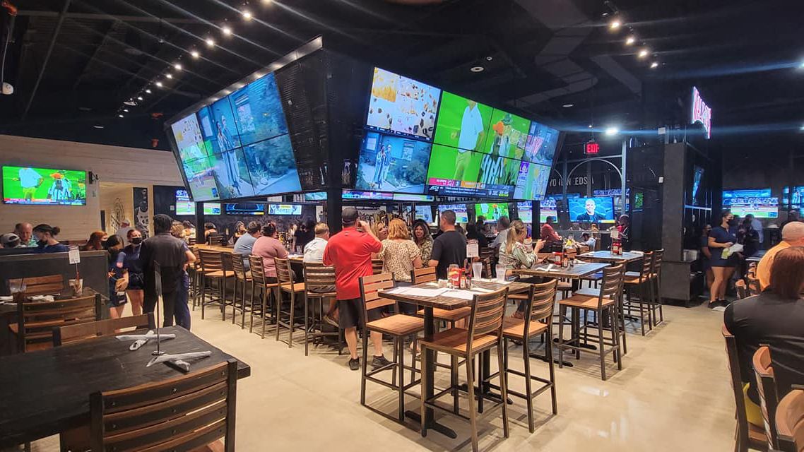 Walk-On&#039;s Sports Bistreaux bar with multiple TVs showing sports. 