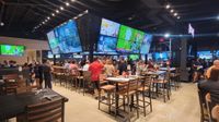 Walk-On's Sports Bistreaux bar with multiple TVs showing sports. 