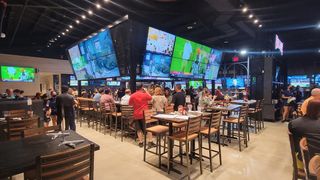 Walk-On's Sports Bistreaux bar with multiple TVs showing sports. 