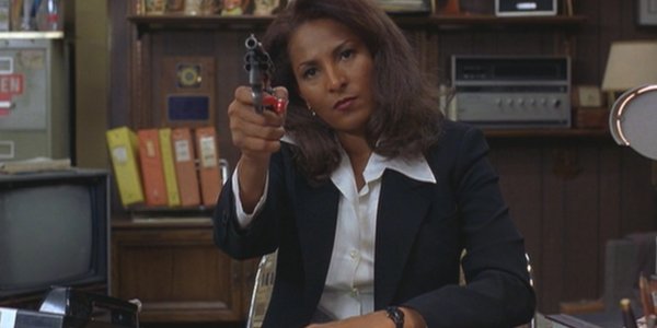 Jackie Brown Pam Grier controlling the room with a revolver