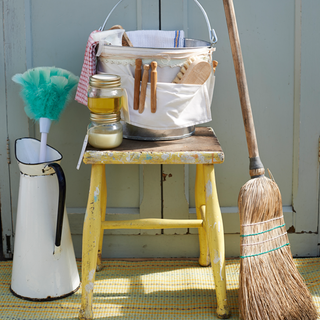 white door bucket table with cleaning essentials