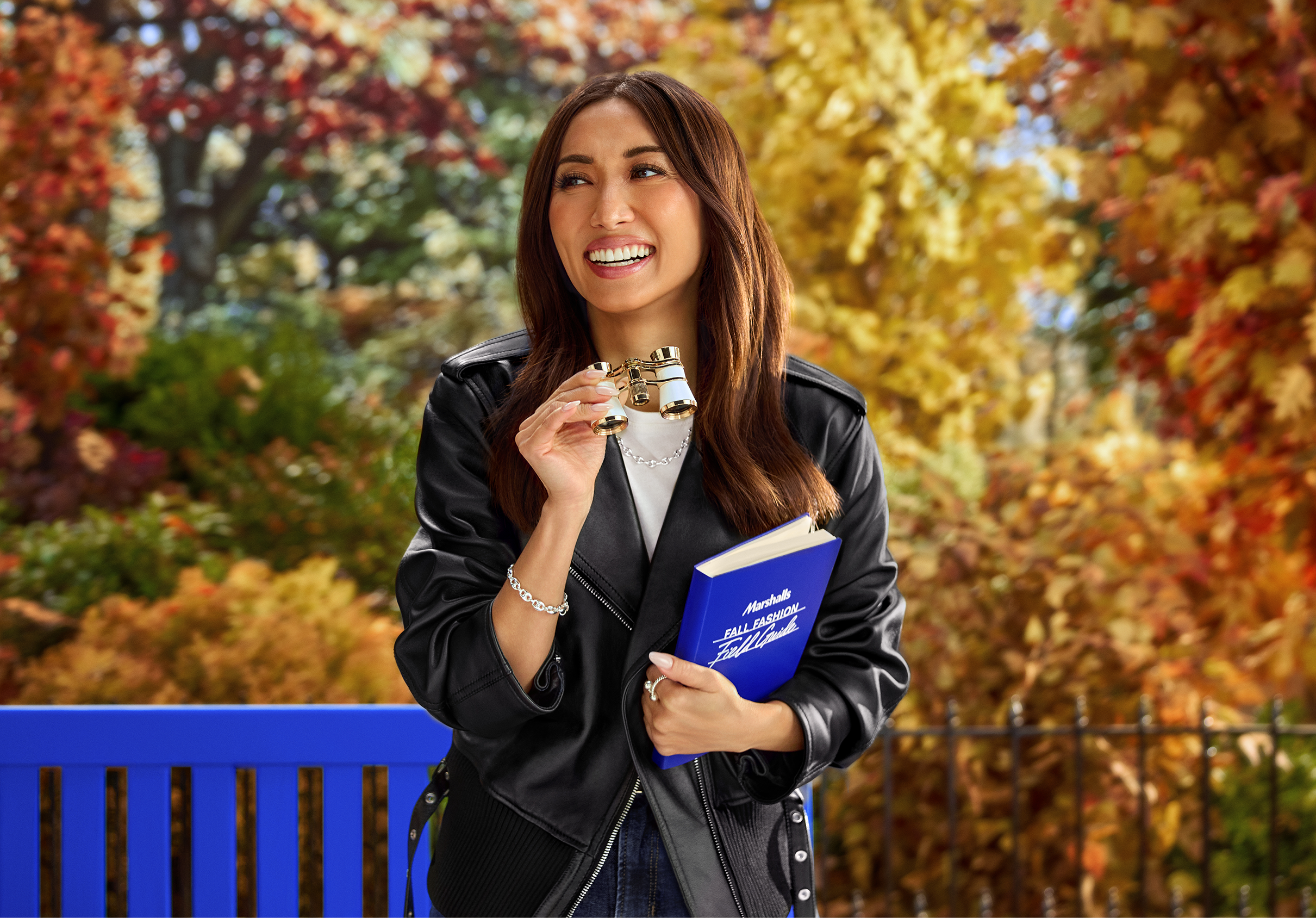 brenda song sitting on a bench in the fall reading the marshalls fall fashion guide