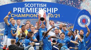 GLASGOW, SCOTLAND - MAY 15: James Tavernier of Rangers lifts the Scottish premiership trophy during the Scottish Premiership match between Rangers and Aberdeen on May 15, 2021 in Glasgow, Scotland. Sporting stadiums around the UK remain under strict restrictions due to the Coronavirus Pandemic as Government social distancing laws prohibit fans inside venues resulting in games being played behind closed doors. (Photo by Ian MacNicol/Getty Images)