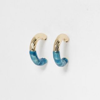 The Camila Blue & Gold Textured Hoop Earrings pictured on a neutral background