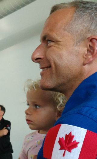 Canadian astronaut David-Saint Jacques holds his youngest child, a toddler, just prior to a presentation at the Montreal Science Centre on July 20, 2018.