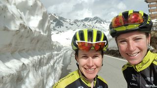 Annemiek van Vleuten and Amanda Spratt at the top of a snowy Passo Gavia
