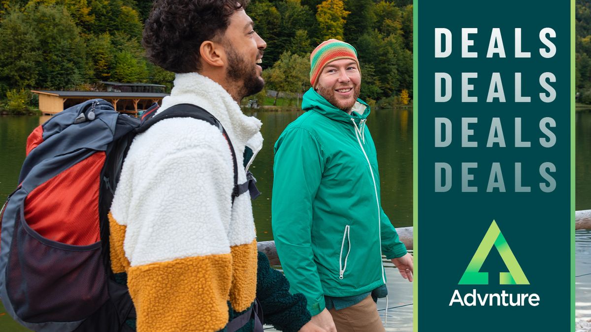 Two men hiking beside lake