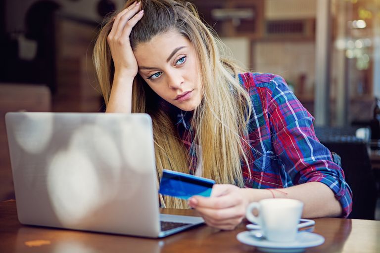 woman with credit card looking stressed