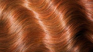 wavy red hair meant to depict the copper hair color trend