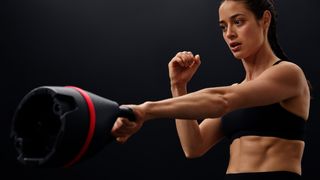 Young attractive female athletge using the Bowflex SelectTech 840 Adjustable Kettlebell