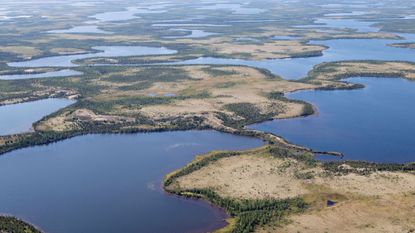 Aerial view of lakes and an esker, a ridge formed by sediment deposited during the last Ice Age, in northern Manitoba, Canada, North America