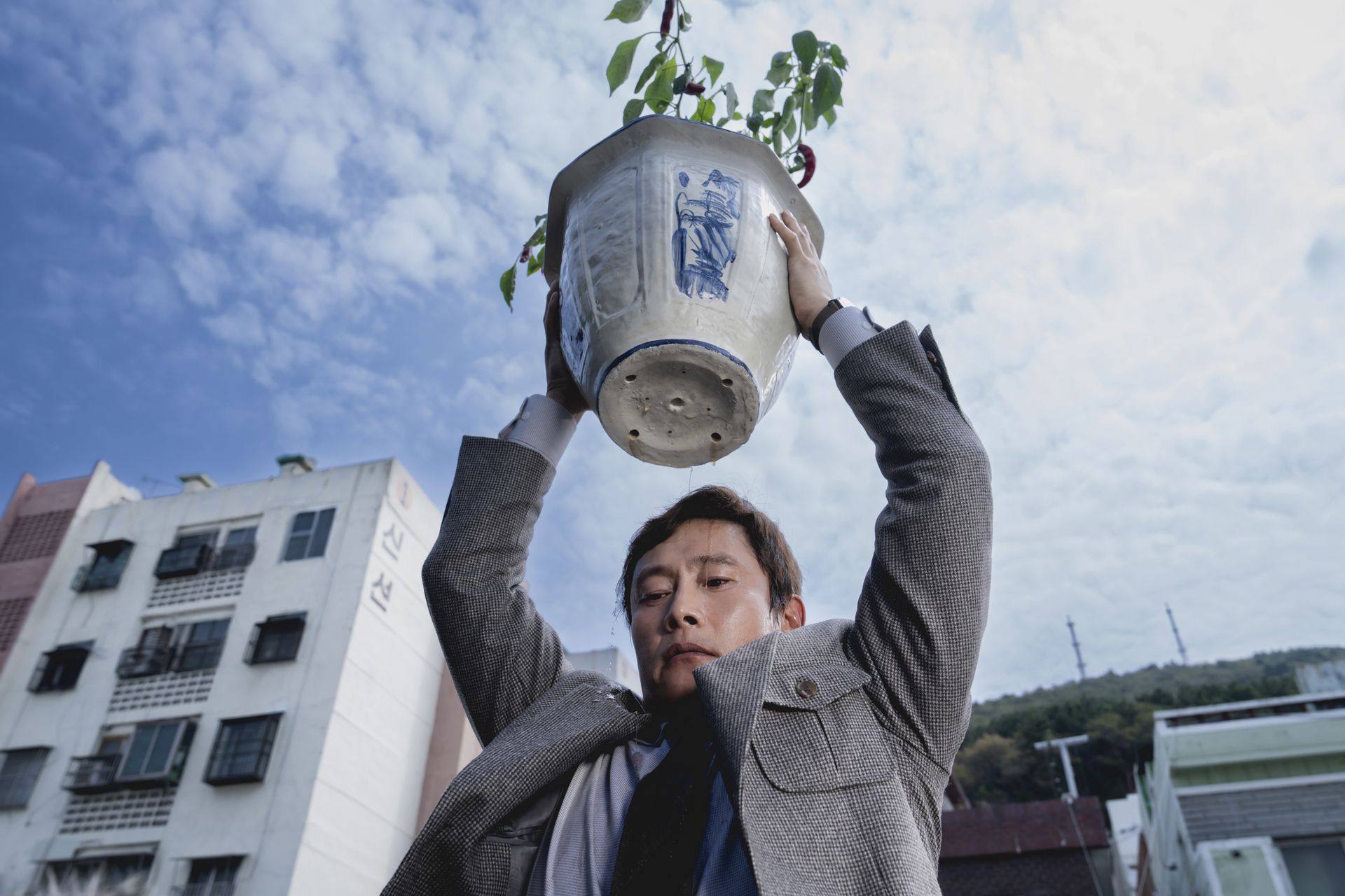 Film still of man about to smash vase
