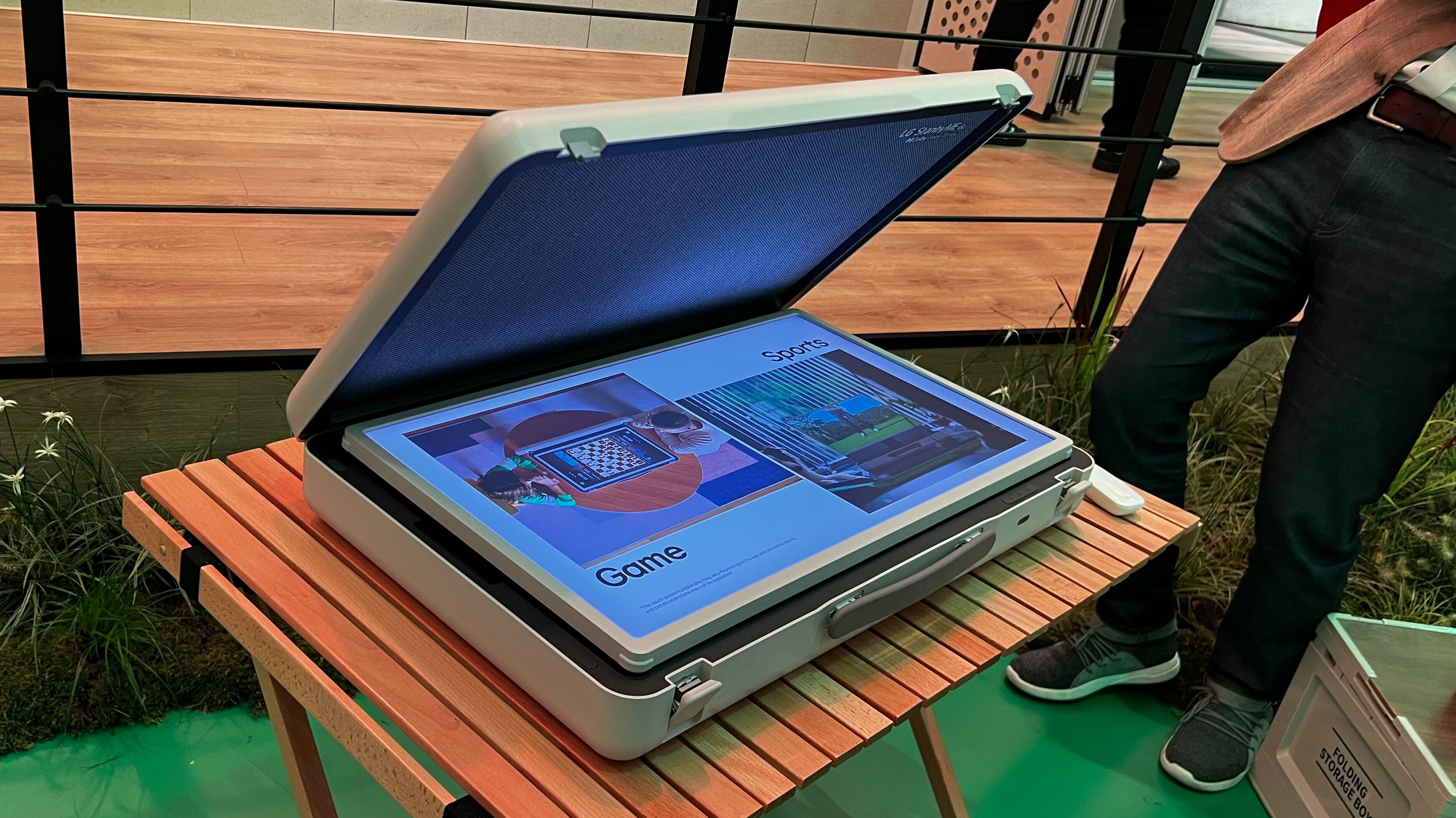 The LG StanbyME Go suitcase TV on a wooden table at the IFA 2023 trade show