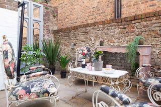 narrow courtyard with mirror and shabby chic furniture
