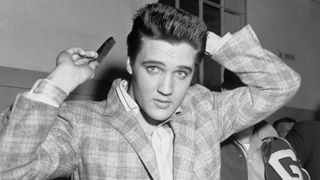 Elvis Presley combs his hair at the Draftee Receiving Depot