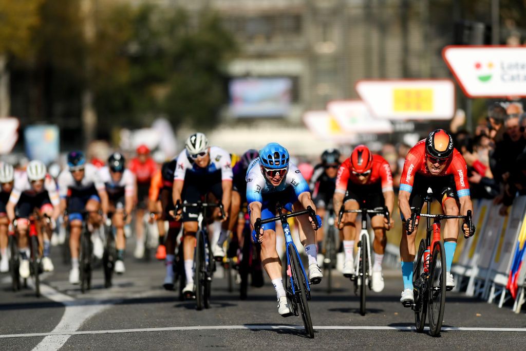 PERPIGNAN FRANCE MARCH 22 LR Kaden Groves of Australia and Team BikeExchange Jayco crosses the finishing line in first place ahead of Phil Bauhaus of Germany and Team Bahrain Victorious during the 101st Volta Ciclista a Catalunya 2022 Stage 2 a 2024km stage from LEscala to Perpignan VoltaCatalunya101 WorldTour on March 22 2022 in Perpignan France Photo by David RamosGetty Images