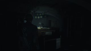 Resident Evil 2 remake locker codes - Leon looks at a desk in the dark with letters hanging above it.