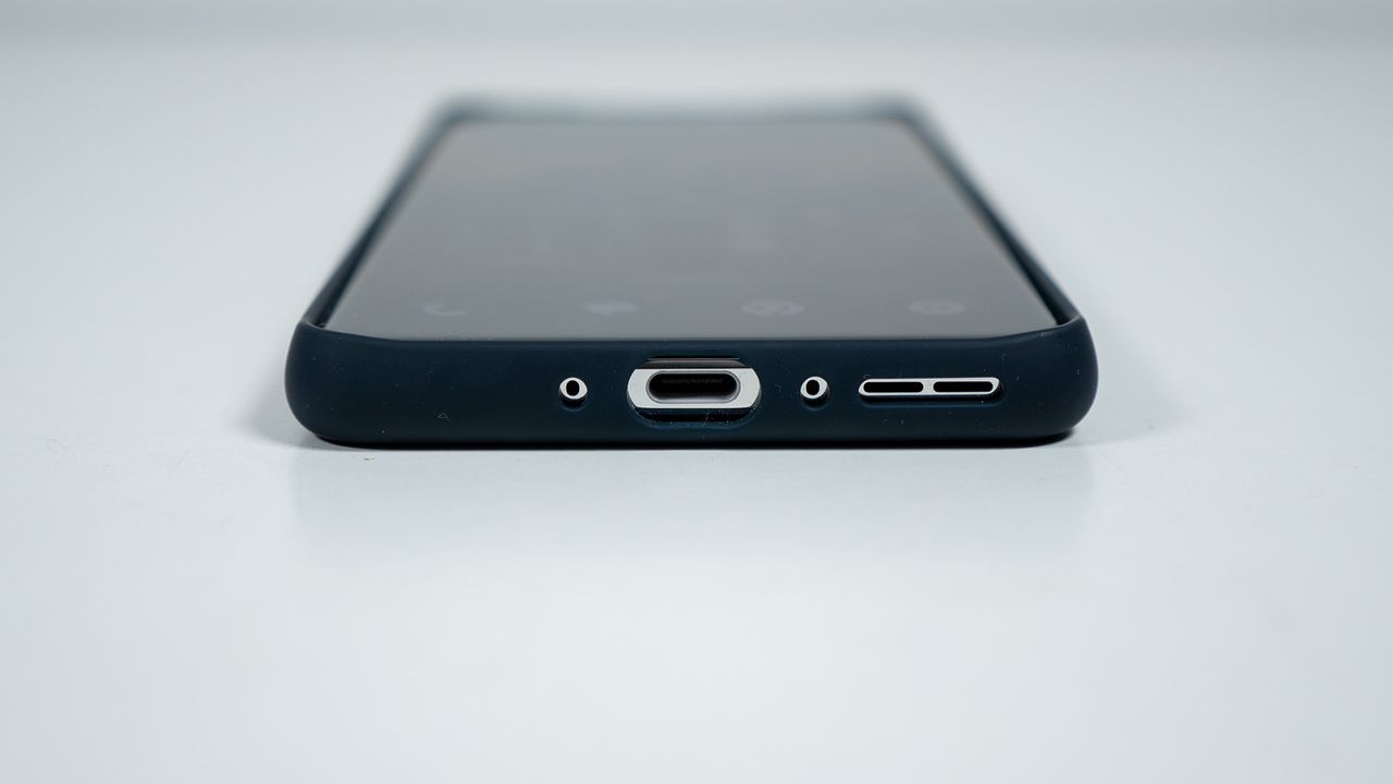 The bottom of the official blue OnePlus 13 soft case