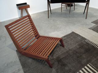 Wooden slatted chair on brown rug