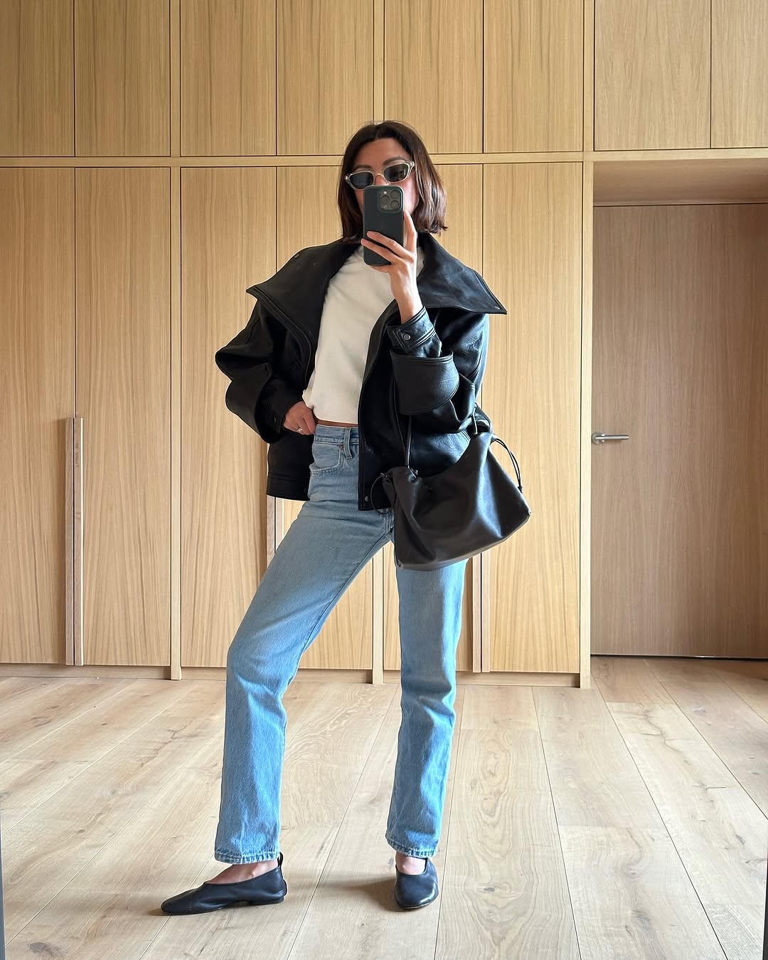 woman wearing slim jeans with leather jacket and ballet flats