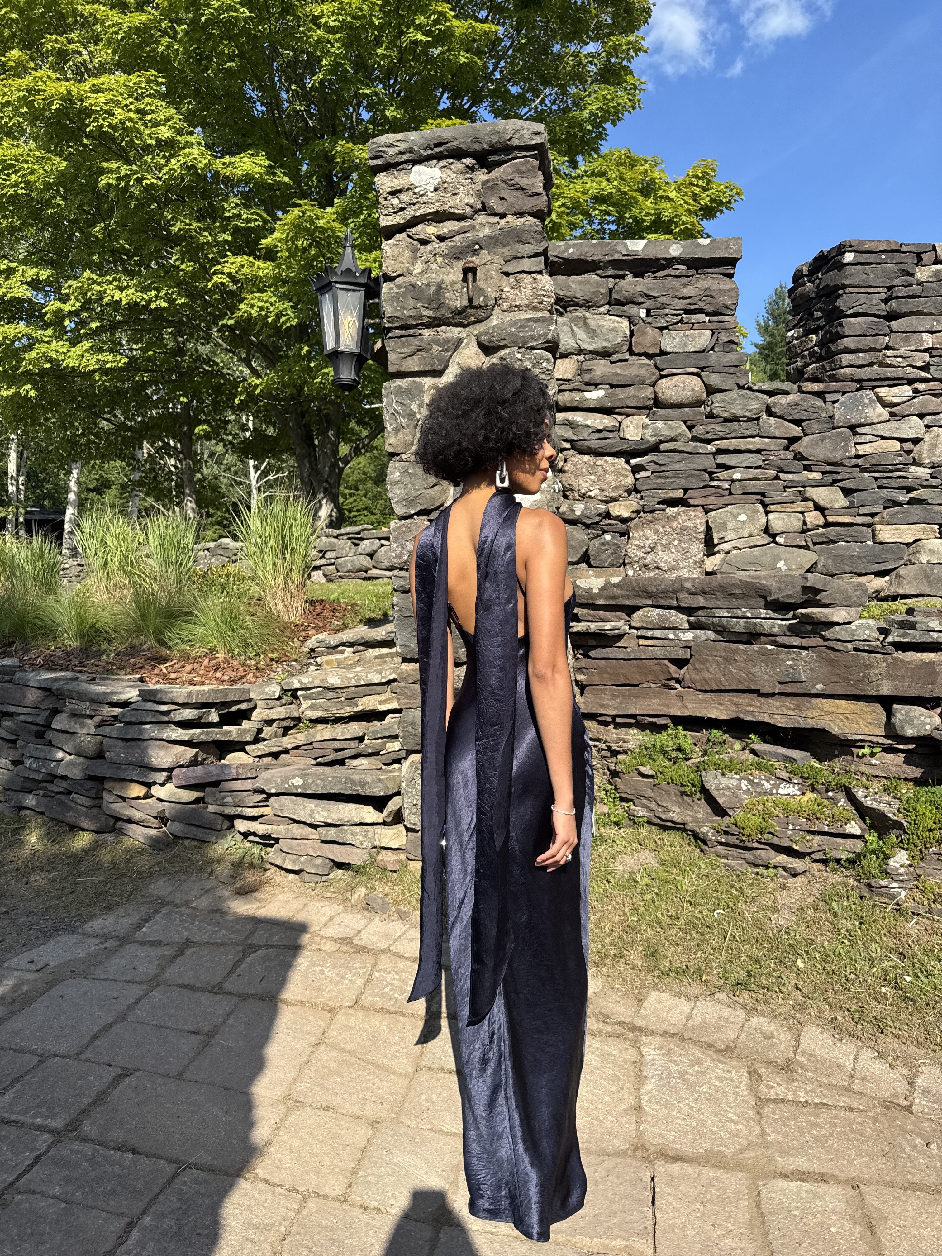 an image of woman at a wedding in a navy blue dress at a wedding courtesy of Mecca James-Williams