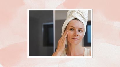 Portrait of a woman with her hair in a towel applying skincare products to her face, with a pink watercolour background