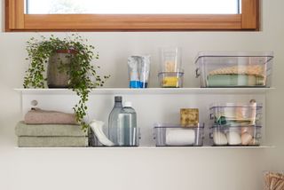 bathroom storage with shelves and clear boxes