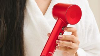 a close up of a woman's hands holding the Laifen Swift hair dryer