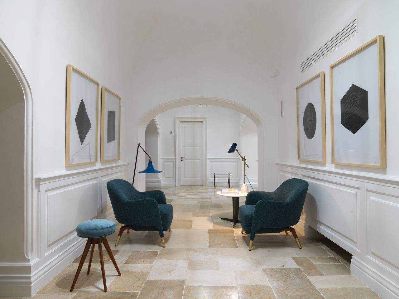 Lobby of a hotel with two dark armchairs