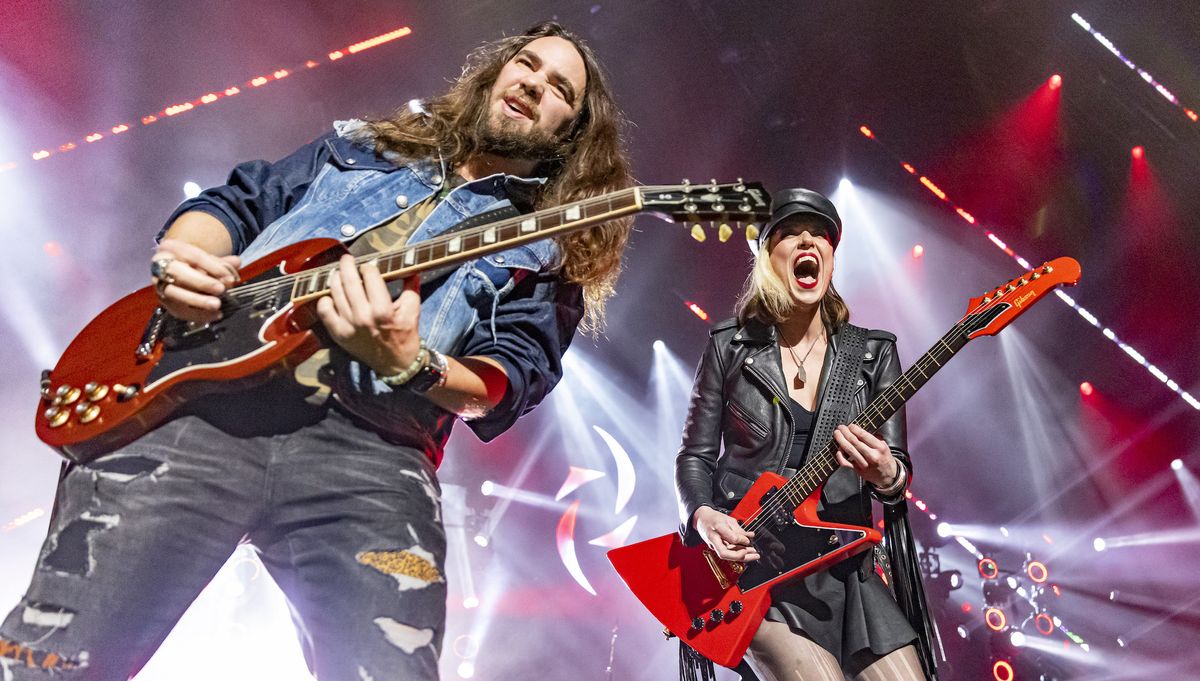 Joe Hottinger (left) and Lzzy Hale of Halestorm perform at Little Caesars Arena on December 11, 2021 in Detroit, Michigan