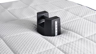 Weight placed in the middle of a Nectar mattress to measure sinkage
