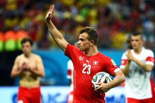 Xherdan Shaqiri, holding the match ball, acknowledges the Switzerland fans after his hat-trick in a 3-0 win over Honduras at the 2014 World Cup.