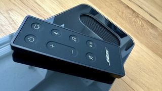 Bose Smart Ultra Soundbar remote on top of the unit