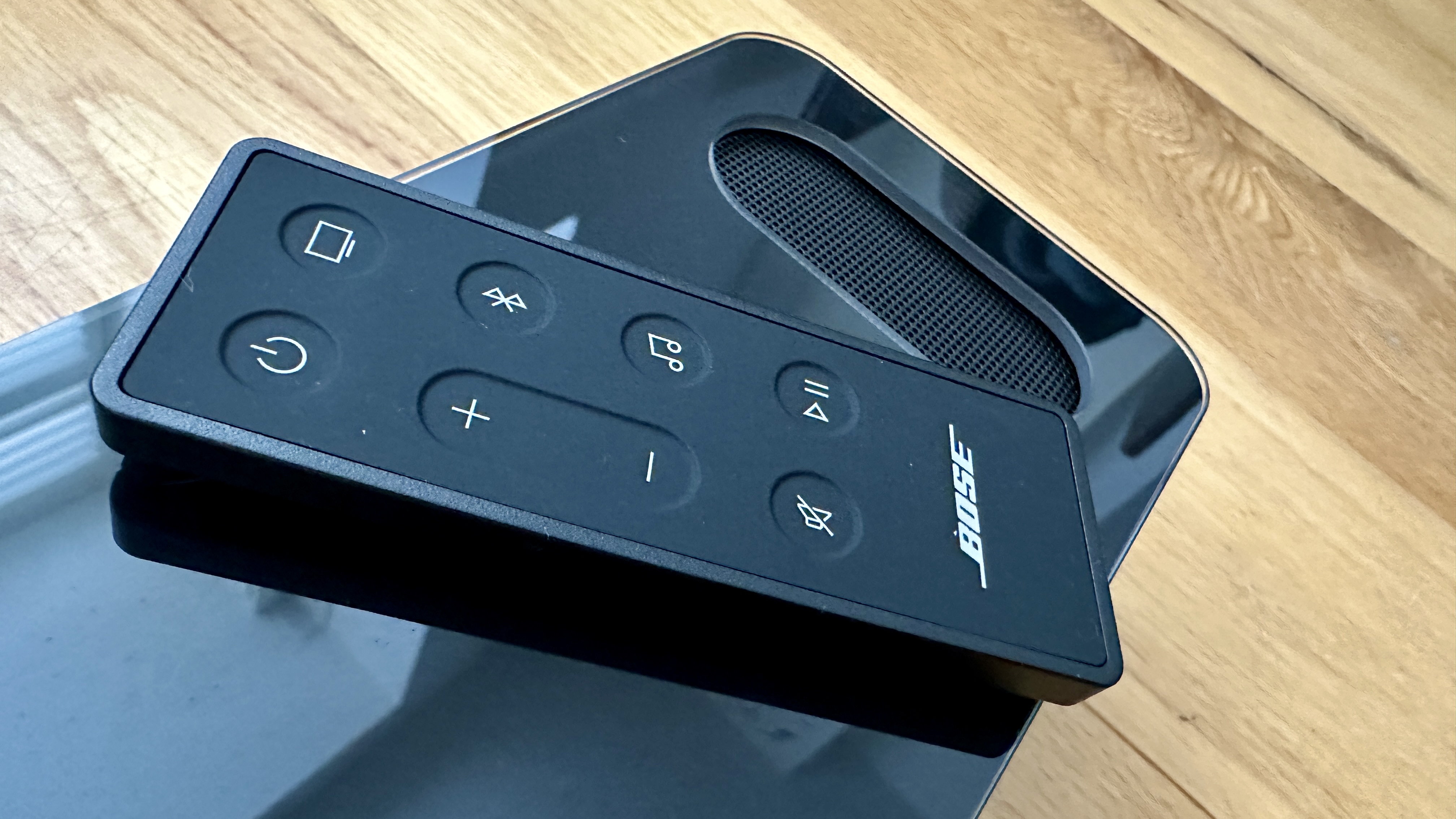 Bose Smart Ultra Soundbar remote on top of the unit